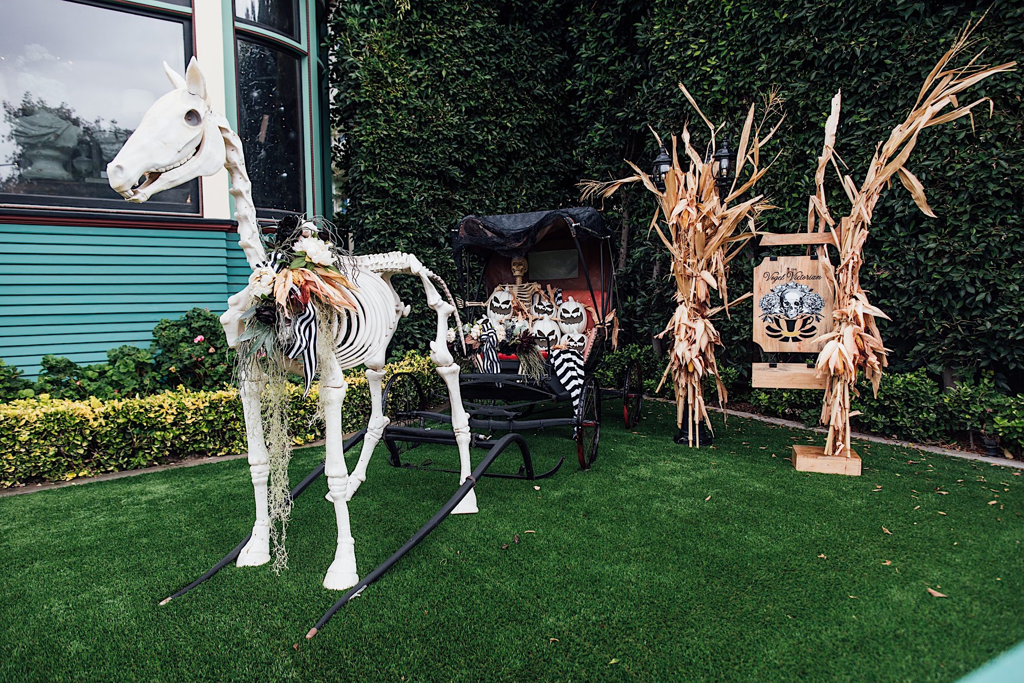 horse skeleton and carriage outside of victorian haunted mansion by photographer Jessica Sofranko