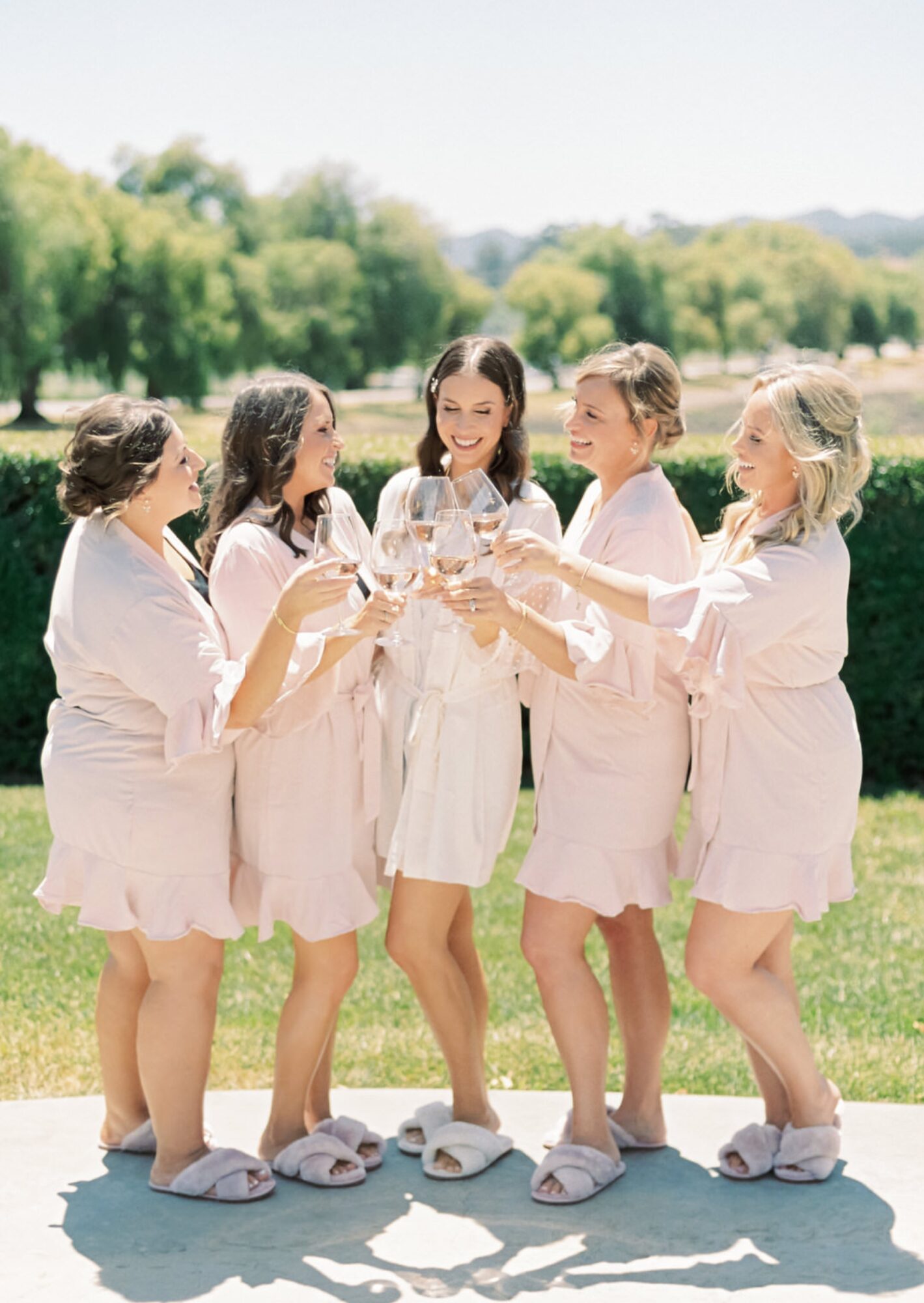 Bride and bridesmaids cheersing champagne at the White Barn Edna Valley photographed by san luis obispo wedding photographers jessica sofranko