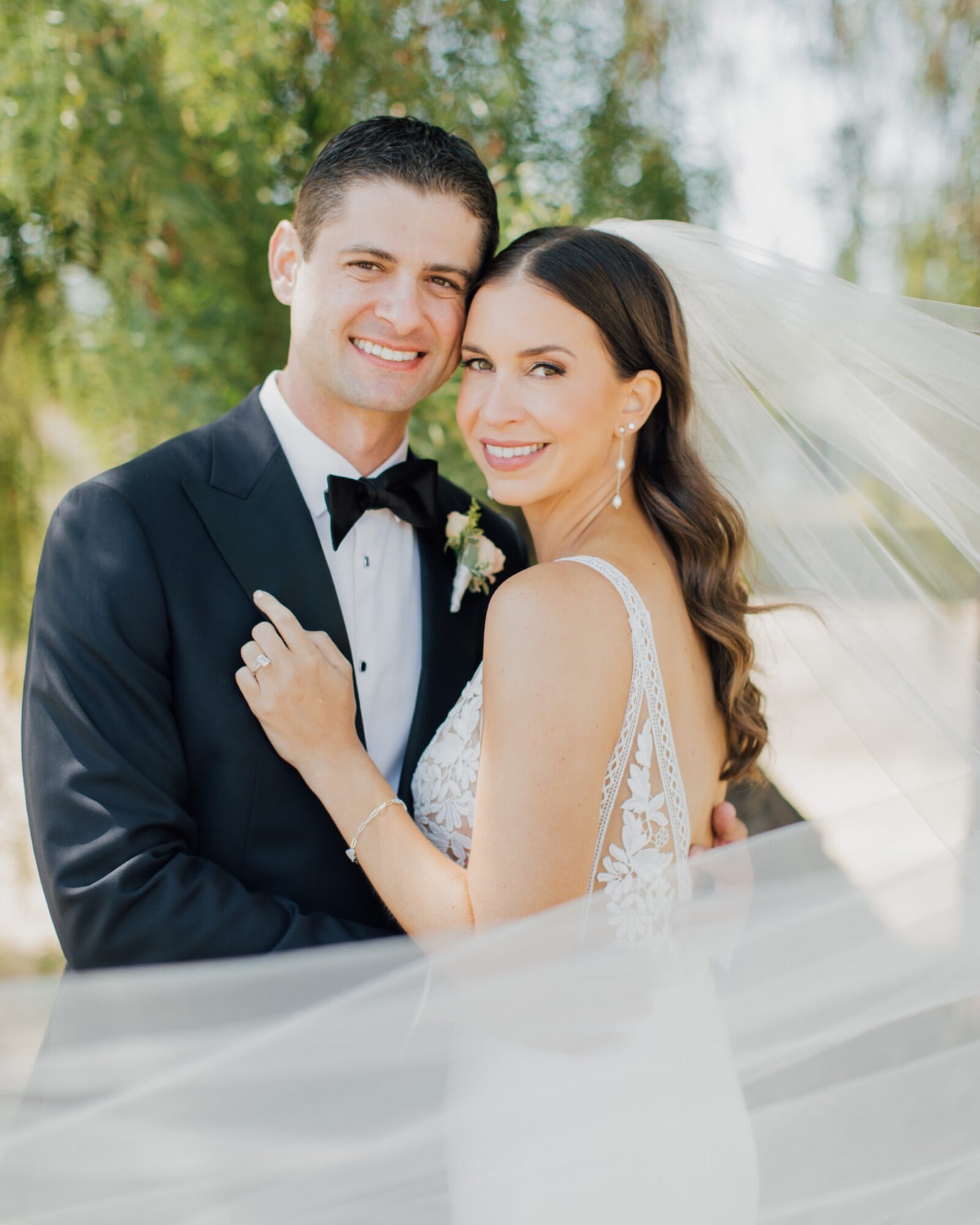portrait of bride and groom with cathedral length veil at the White Barn Edna Valley photographed by san luis obispo wedding photographers jessica sofranko