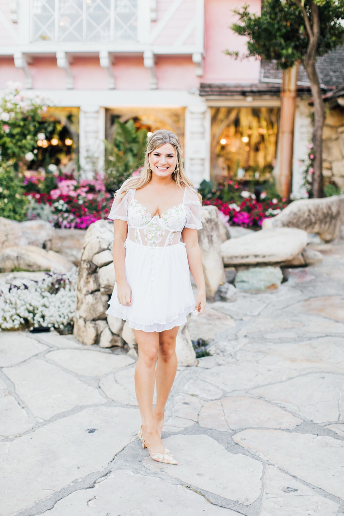 Photo of bride during bachelorette party at Madonna Inn Garden front of Copper Cafe celebrating before her wedding