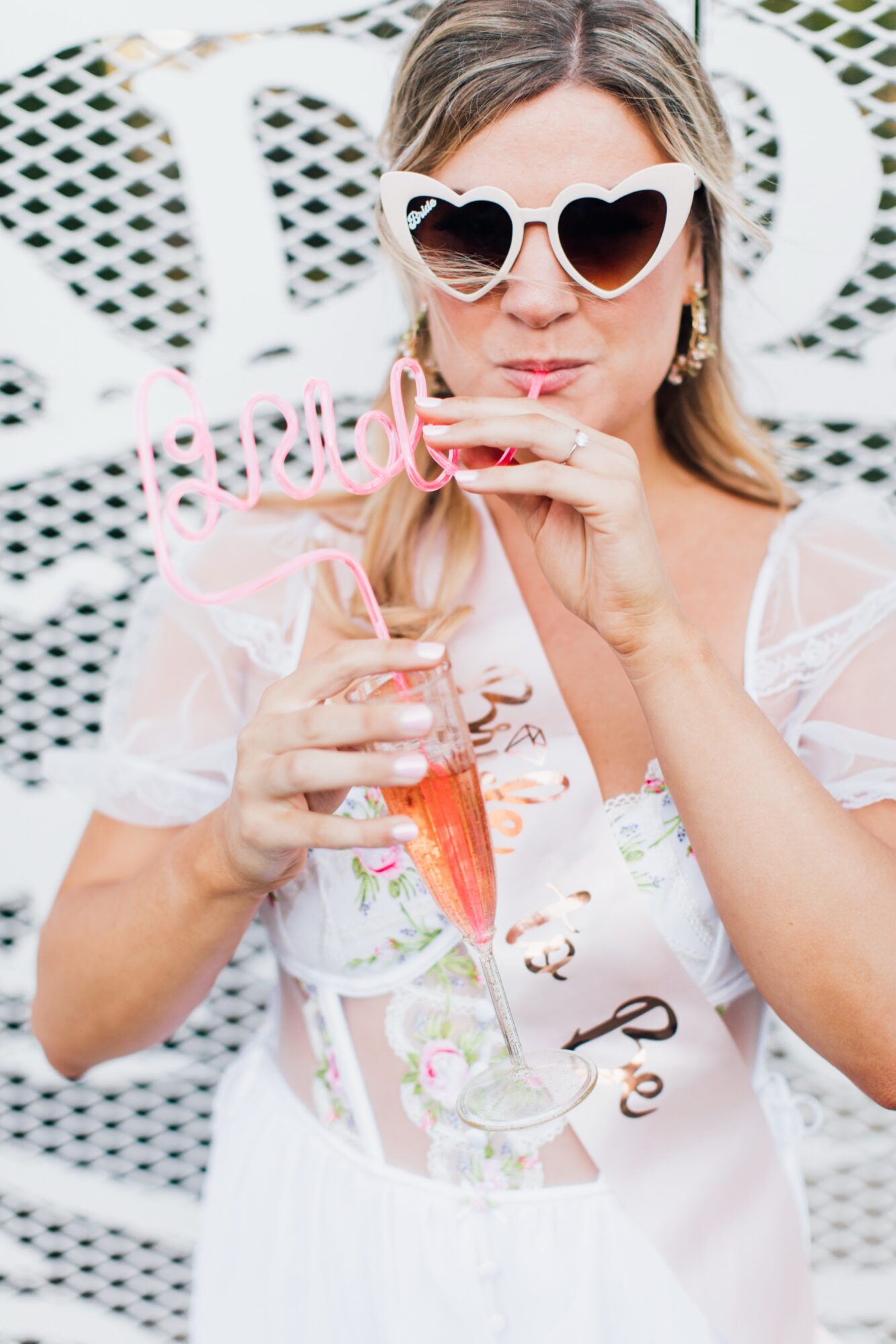 Photo of bride during bachelorette party at Madonna Inn Secret Garden front of Copper Cafe celebrating before her wedding