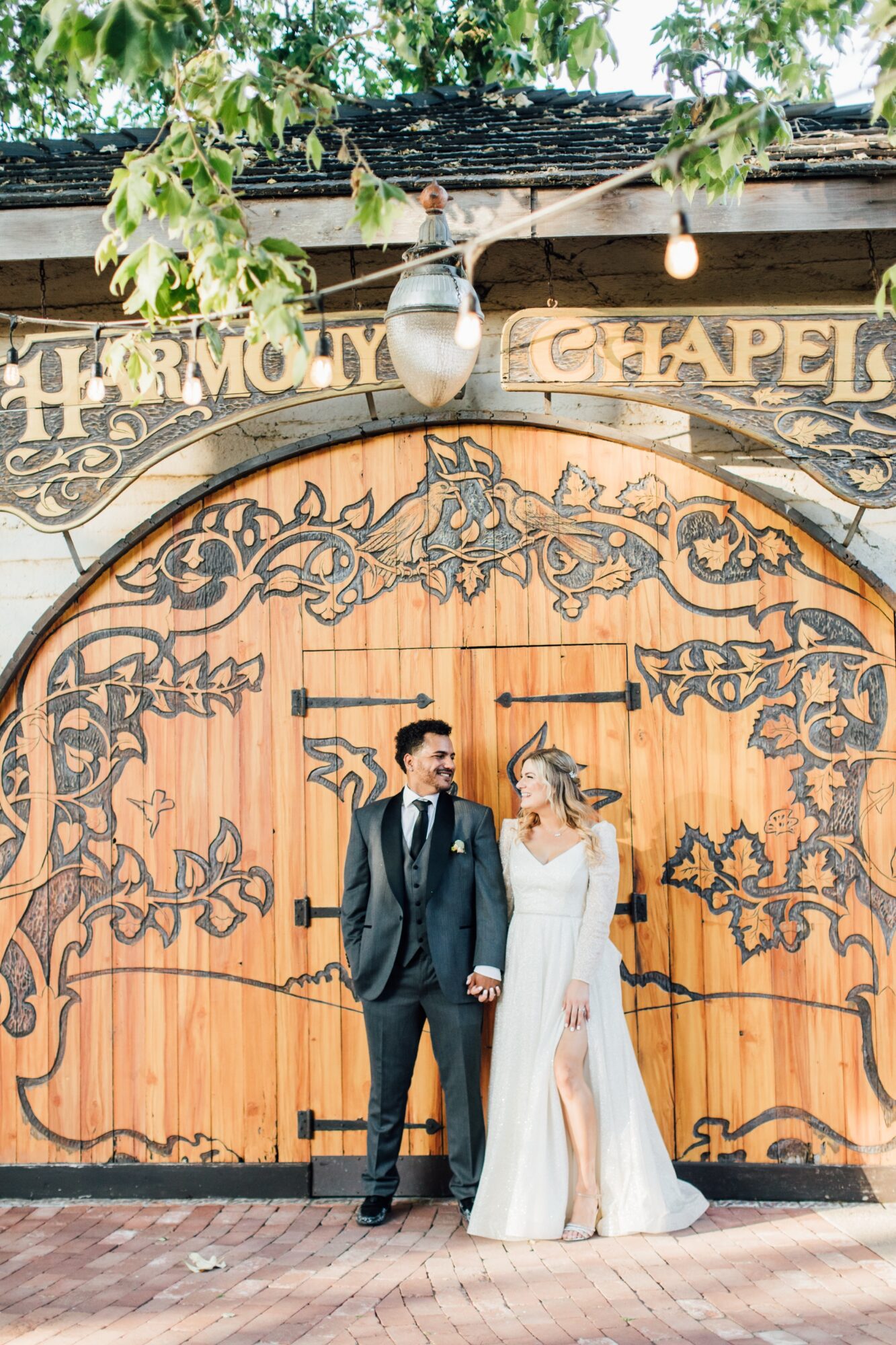 couple in front of harmony chapel doors at Harmony Chapel wedding in Cambria, CA