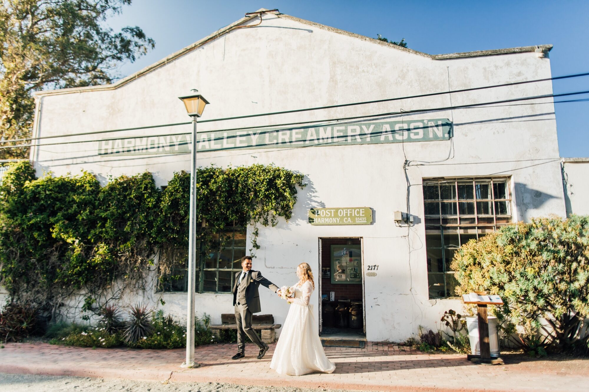 bride & groom in front of post office creamery at Harmony Chapel wedding in Cambria, CA