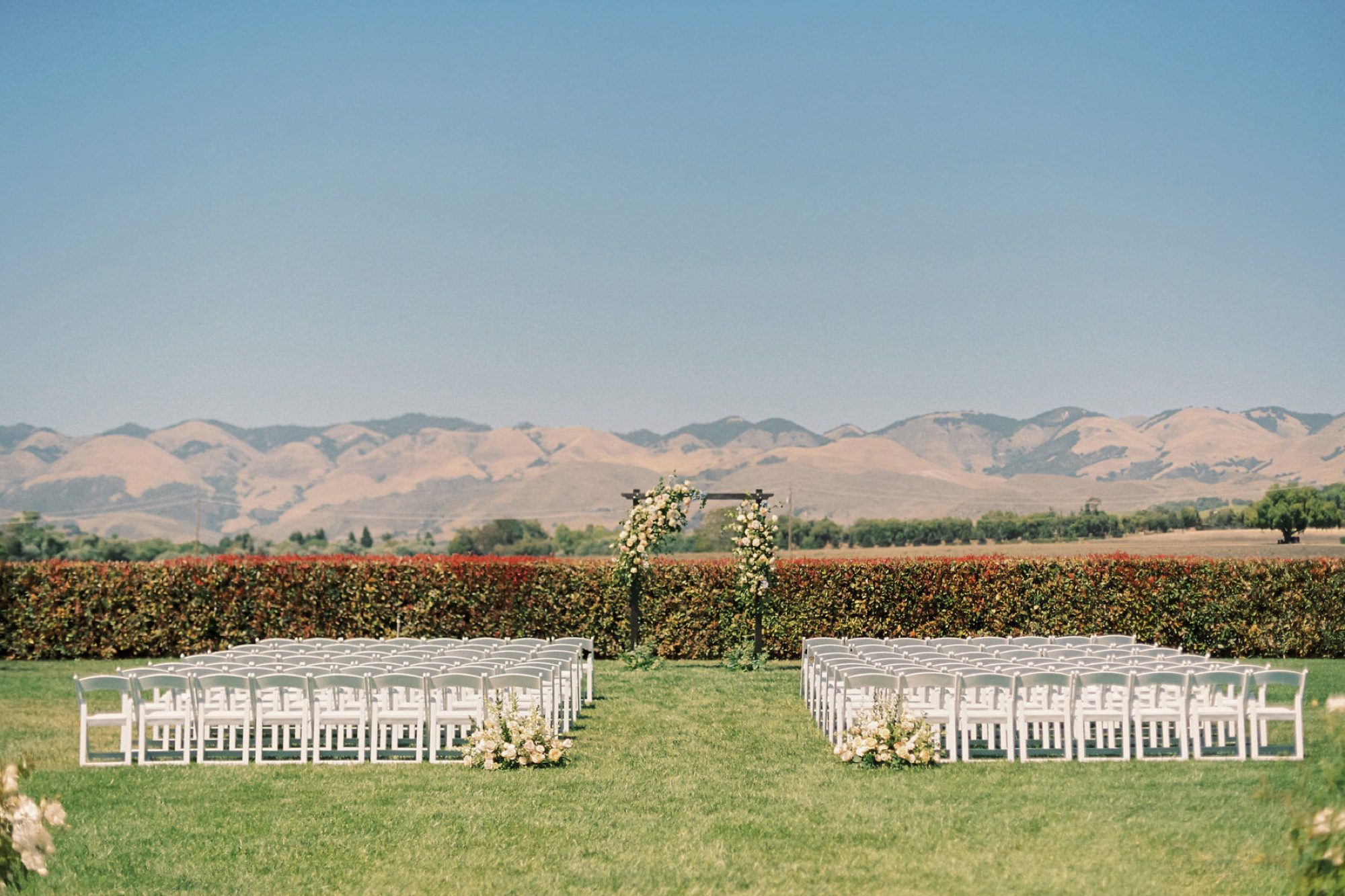Ceremony site with Elyse Events set up with a view of rolling hills of San Luis Obispo at the White Barn Edna Valley photographed by wedding photographers jessica sofranko