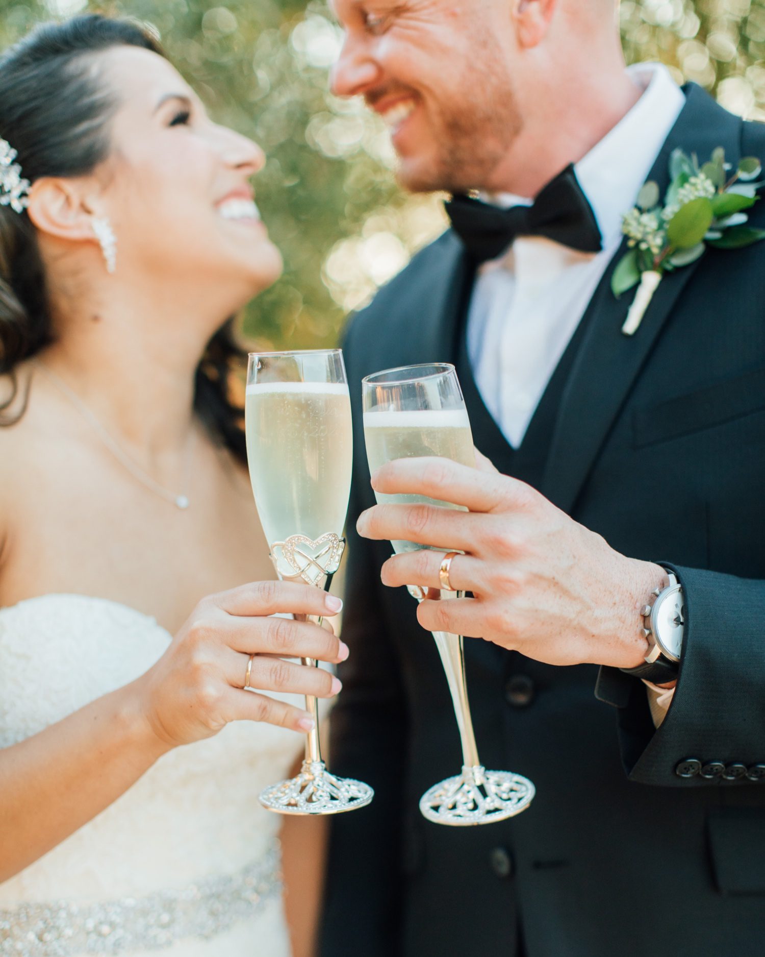 Bride and Groom drinking champagne while smiling at each other