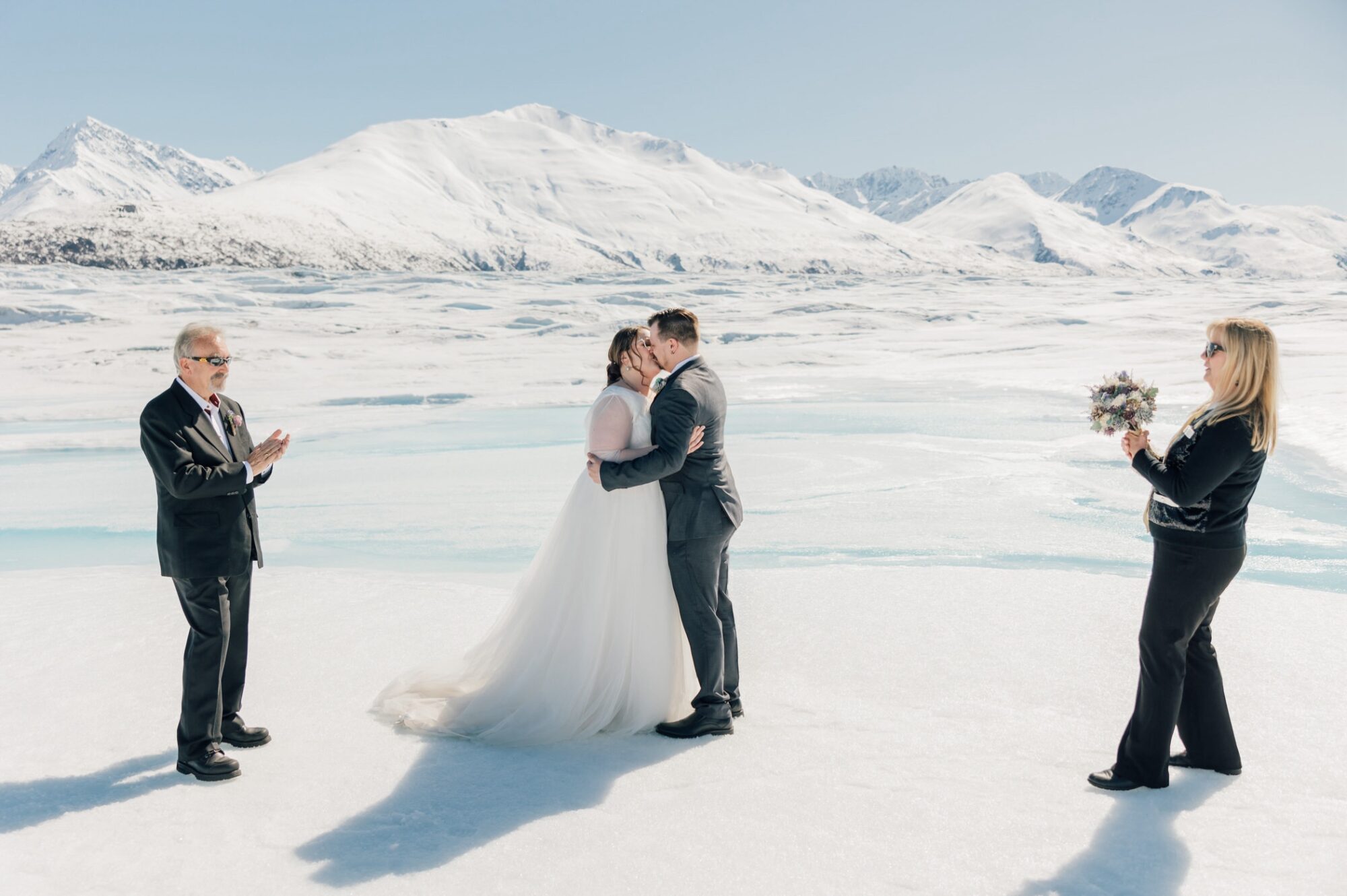 first kiss during elopement ceremony on Knik Glacier by destination wedding photographer Jessica Sofranko