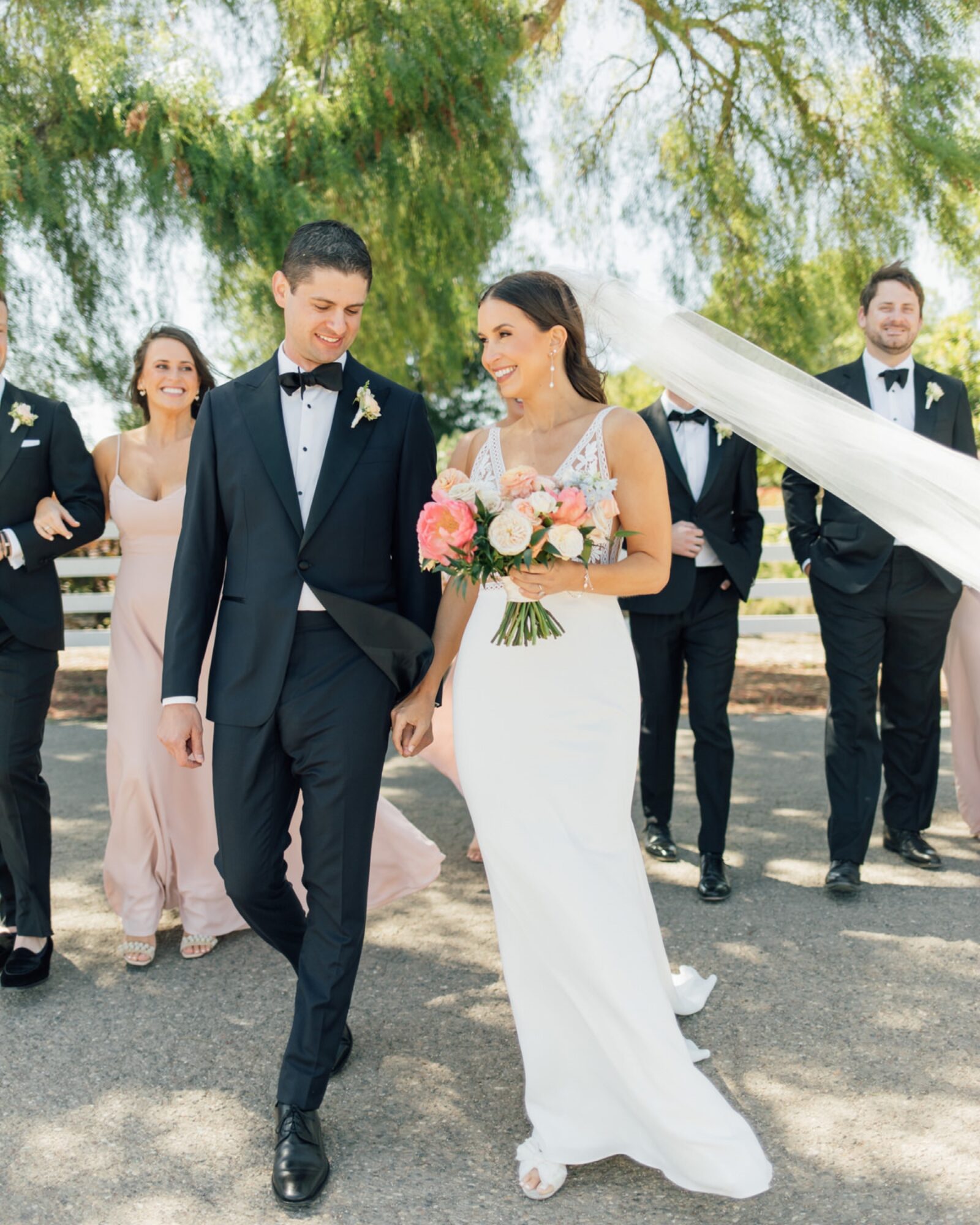 brie and groom walking with wedding party at at the White Barn Edna Valley photographed by san luis obispo wedding photographers jessica sofranko