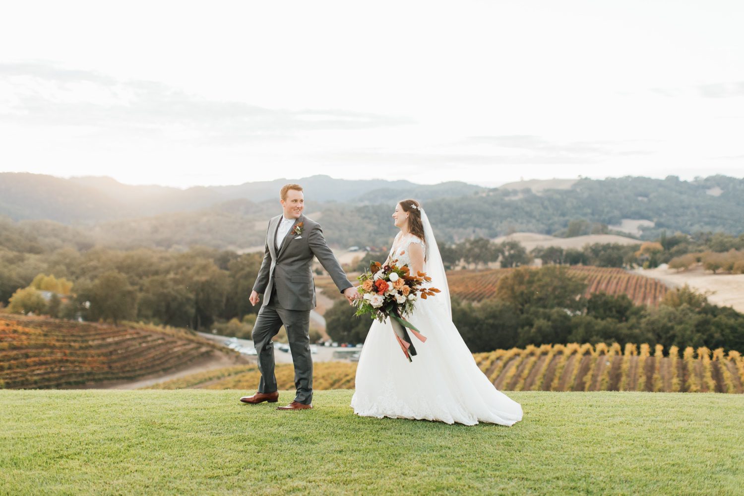 Groom leading bride on a hill in California
