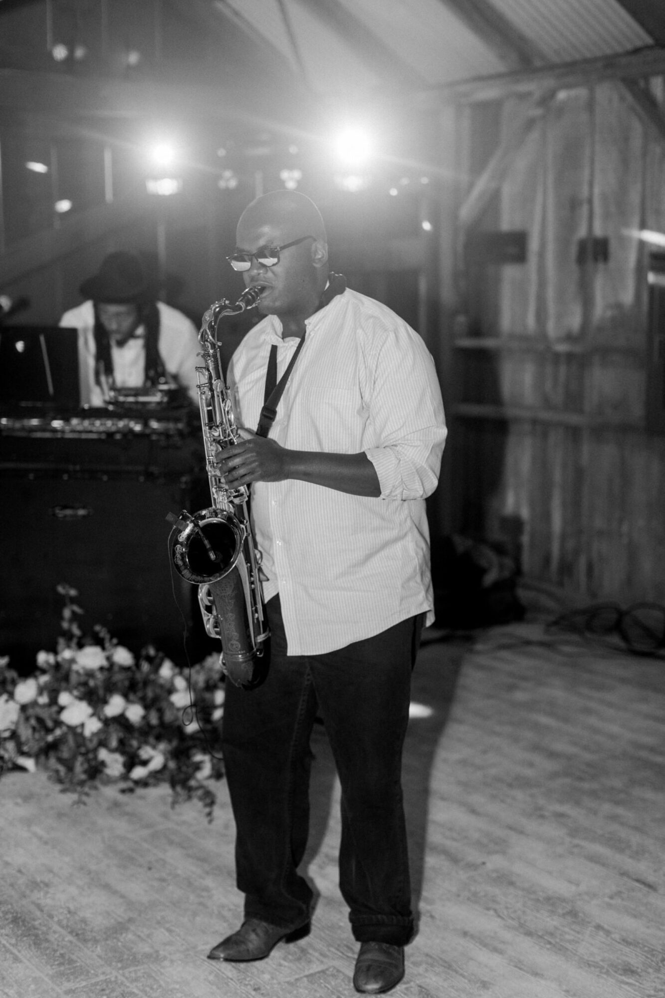 Saxophone musician playing jazz music with dj for dance floor at a wedding in at the White Barn Edna Valley photographed by san luis obispo wedding photographers jessica sofranko