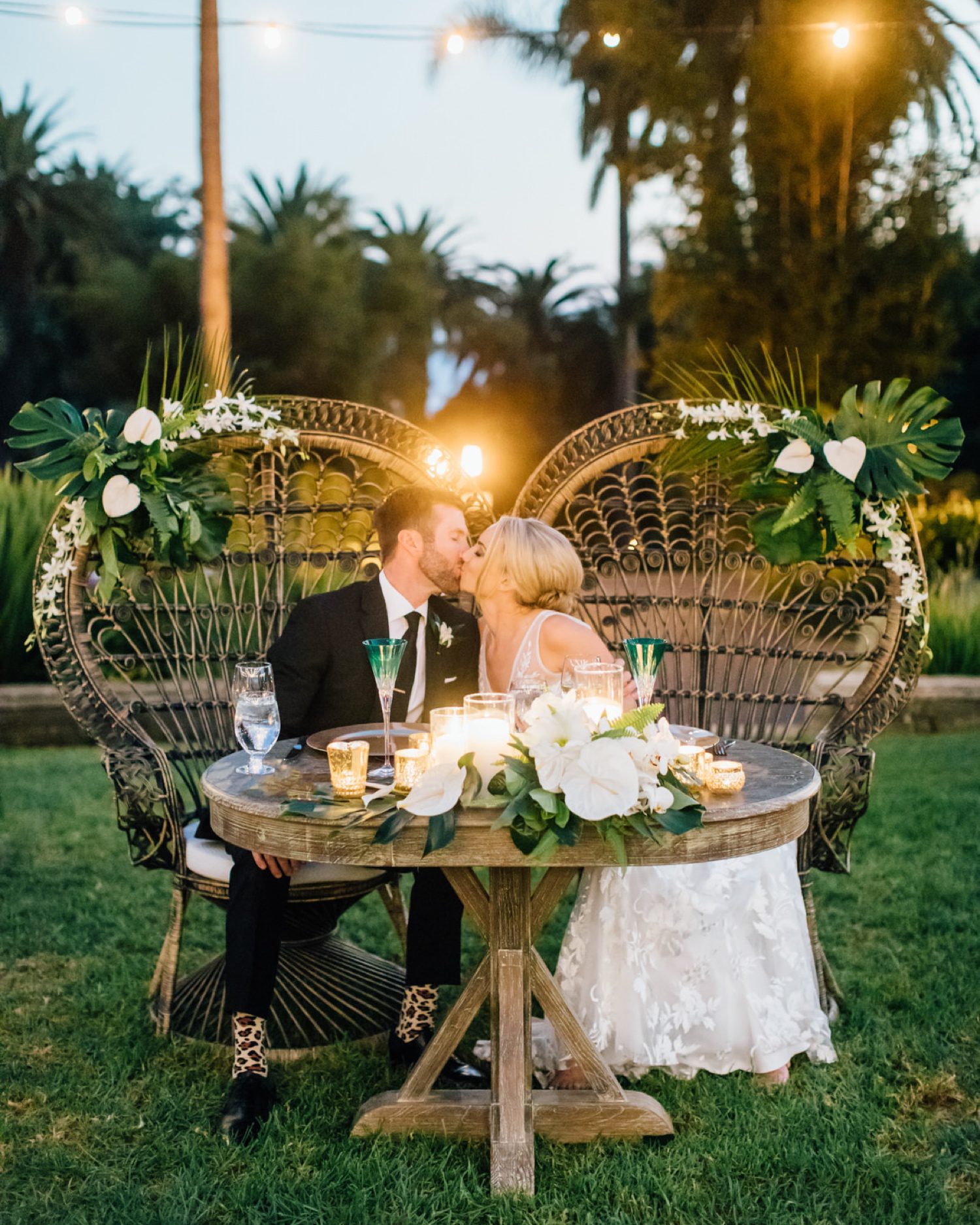 Tropical Wedding Table Display as Bride and Groom Kiss