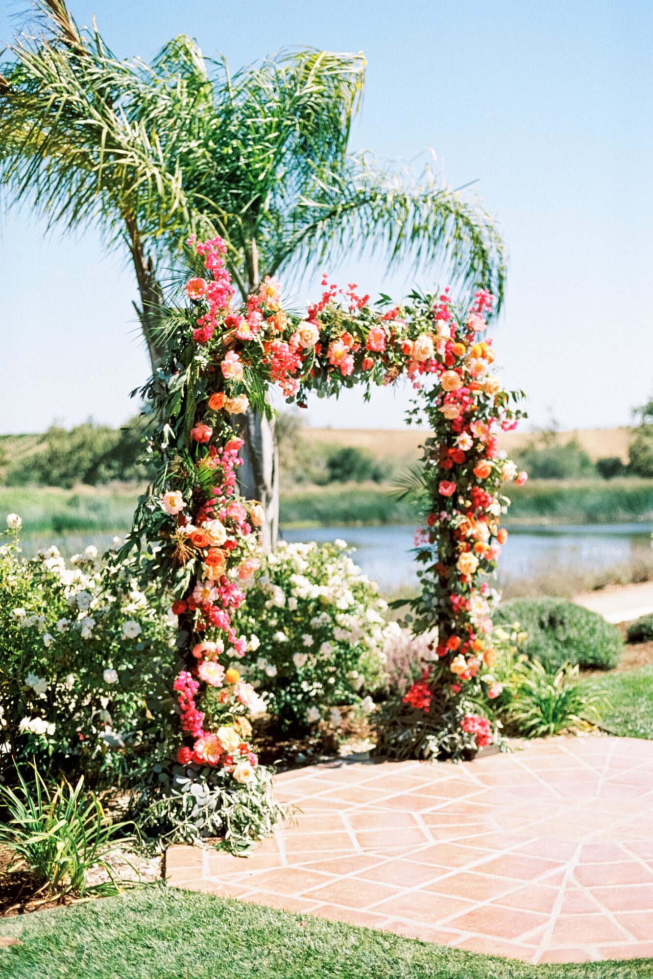 Bright tropical ceremony flowers by Fluid Bloom at La Lomita Ranch in San Luis Obispo by photographer Jessica Sofranko
